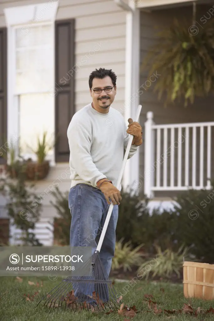 Man raking leaves in front yard