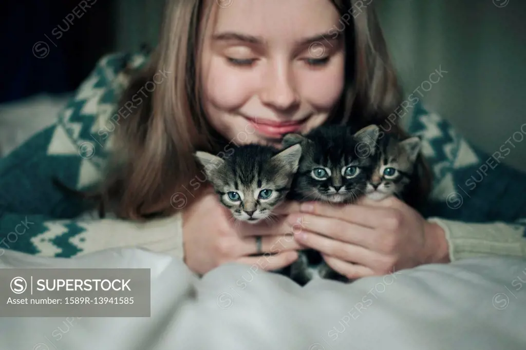 Caucasian woman cuddling kittens
