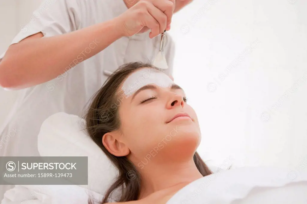 Woman having facial spa treatment