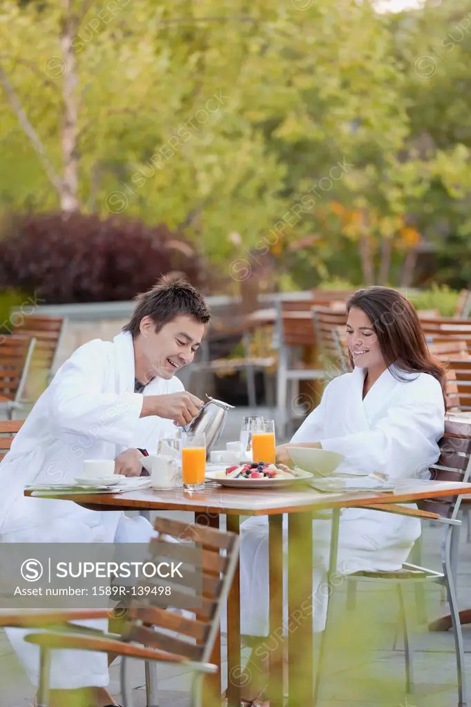 Couple enjoying breakfast on outdoor patio