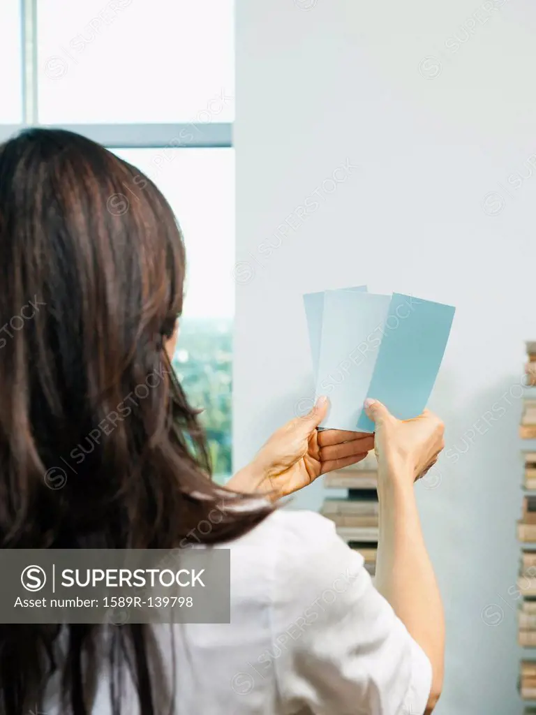 Mixed race woman looking at color swatches