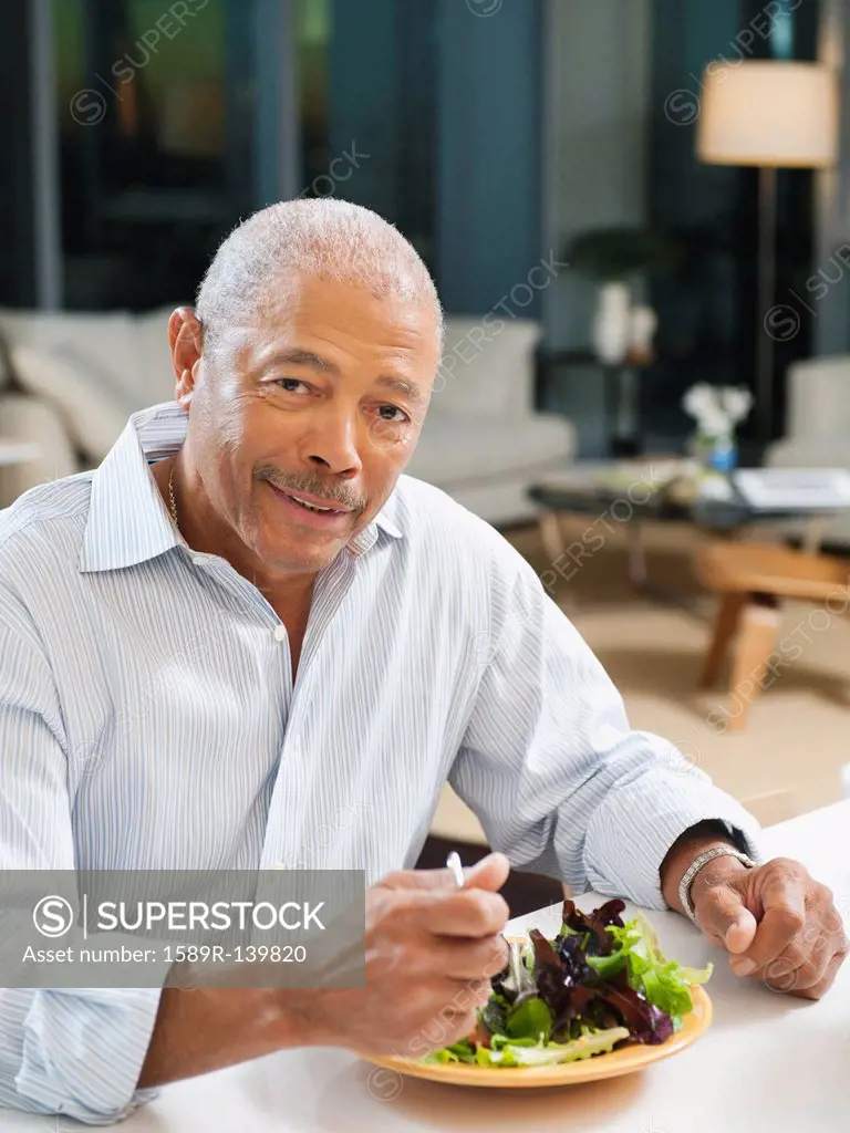 Black man eating salad