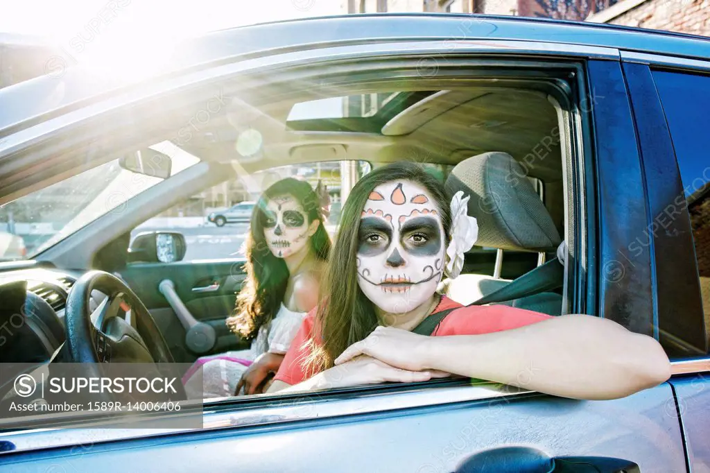 Women in car wearing skull face paint