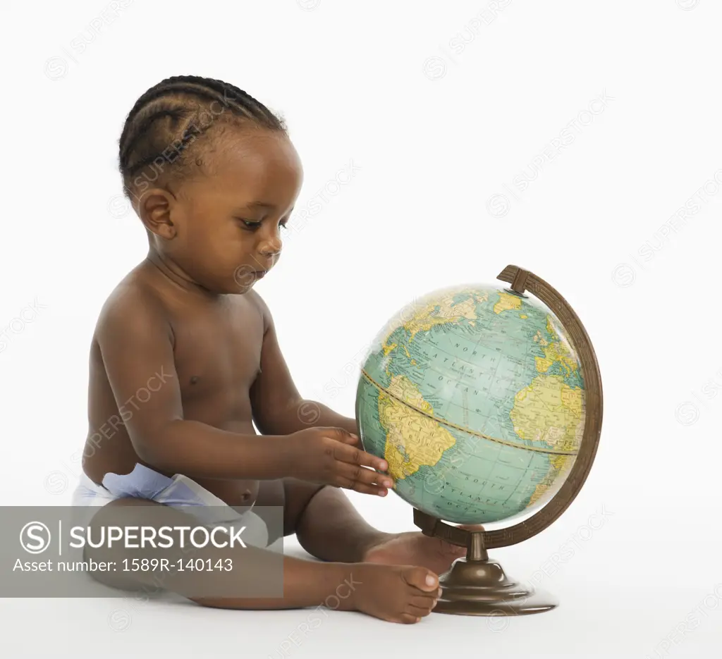 African American baby looking at globe