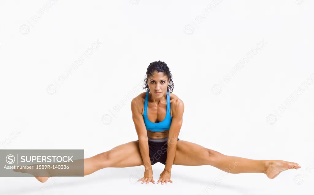 Mixed race woman gymnast balancing on hands