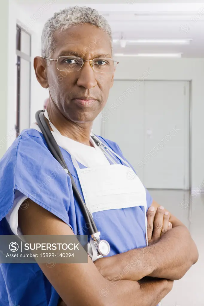 Mixed race surgeon with arms crossed