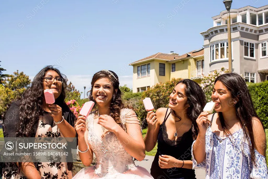 Hispanic girls eating popsicles