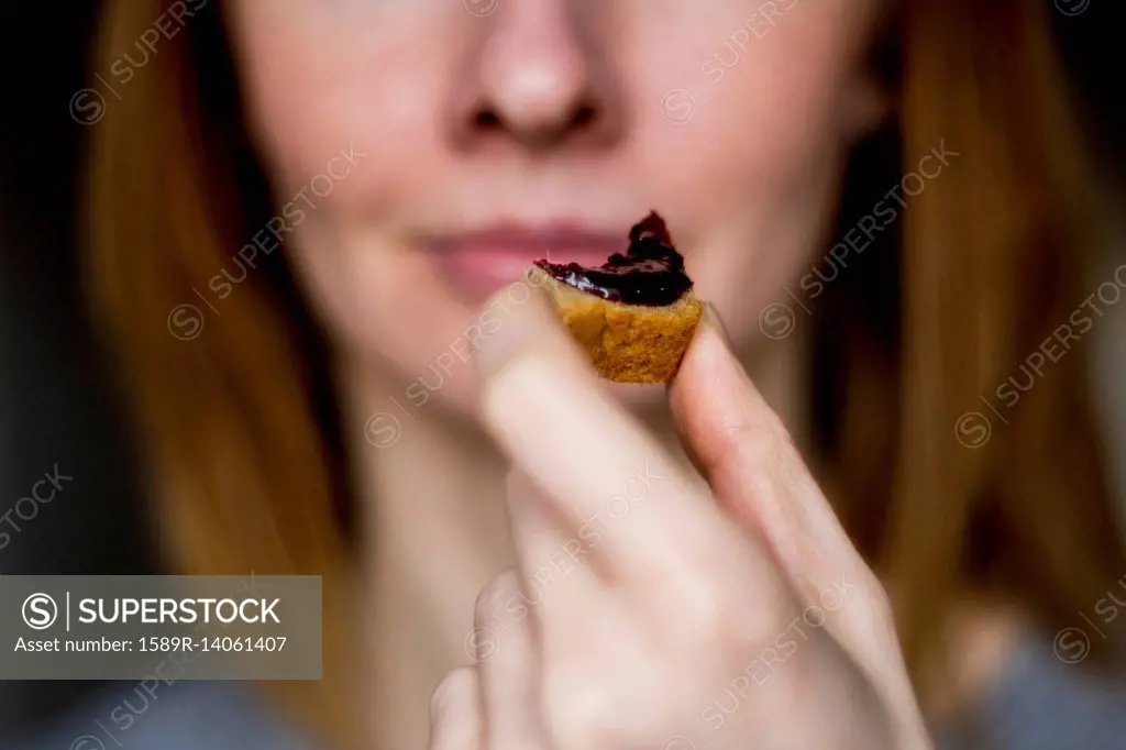 Close up of woman holding bread with jam