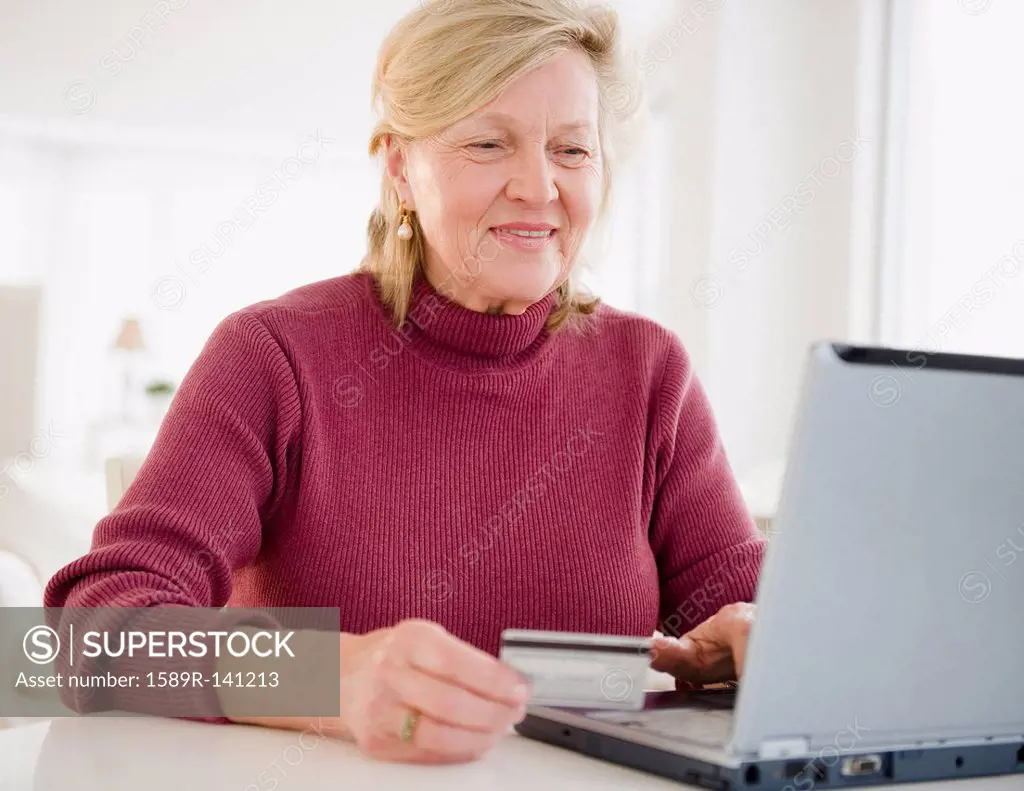 Caucasian woman shopping online with credit card