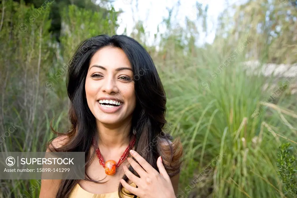 Laughing Indian woman standing outdoors