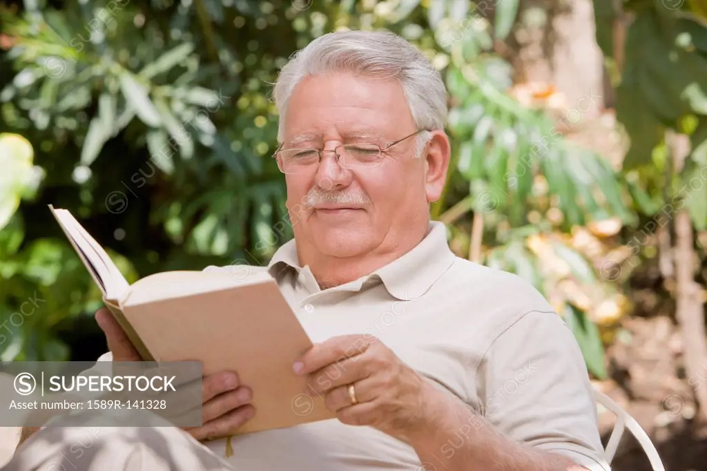 Senior Chilean man reading book