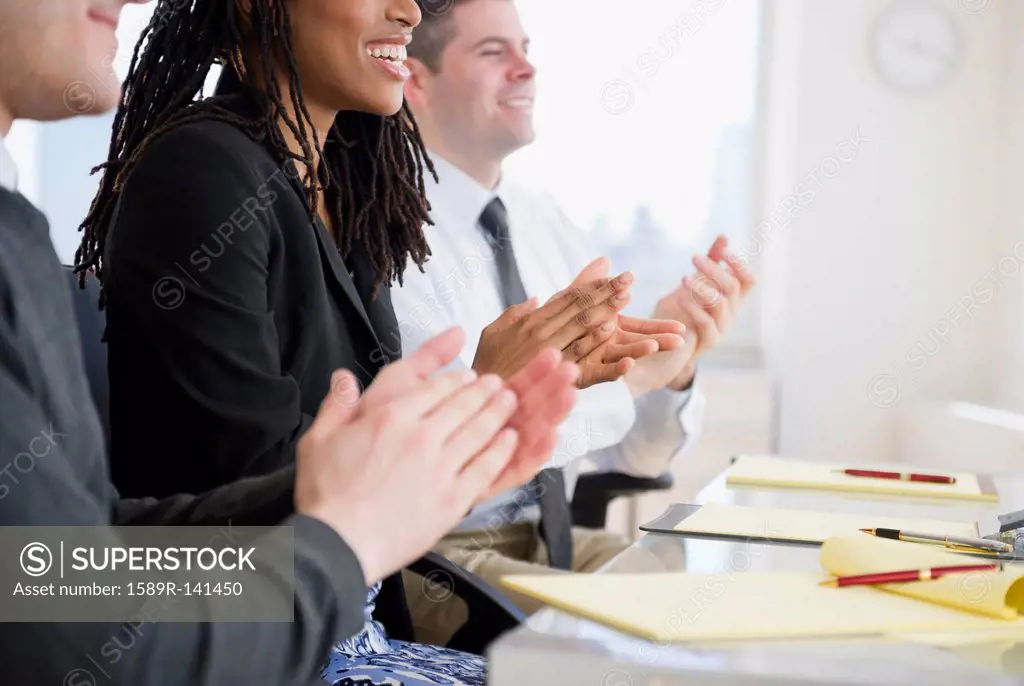 Business people clapping in meeting