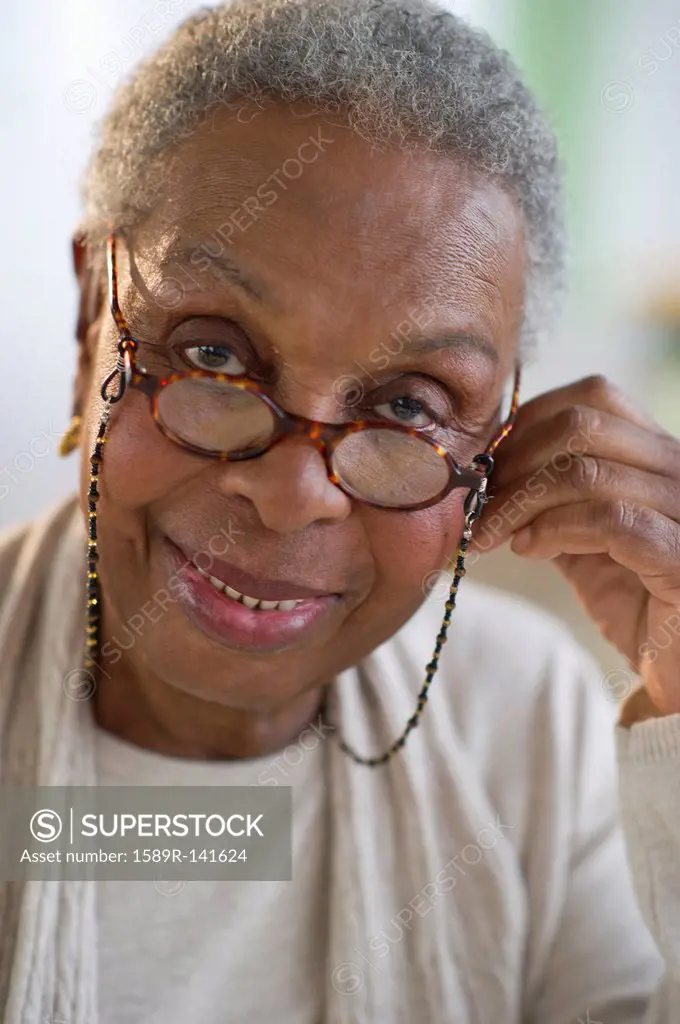 Black woman adjusting eyeglasses