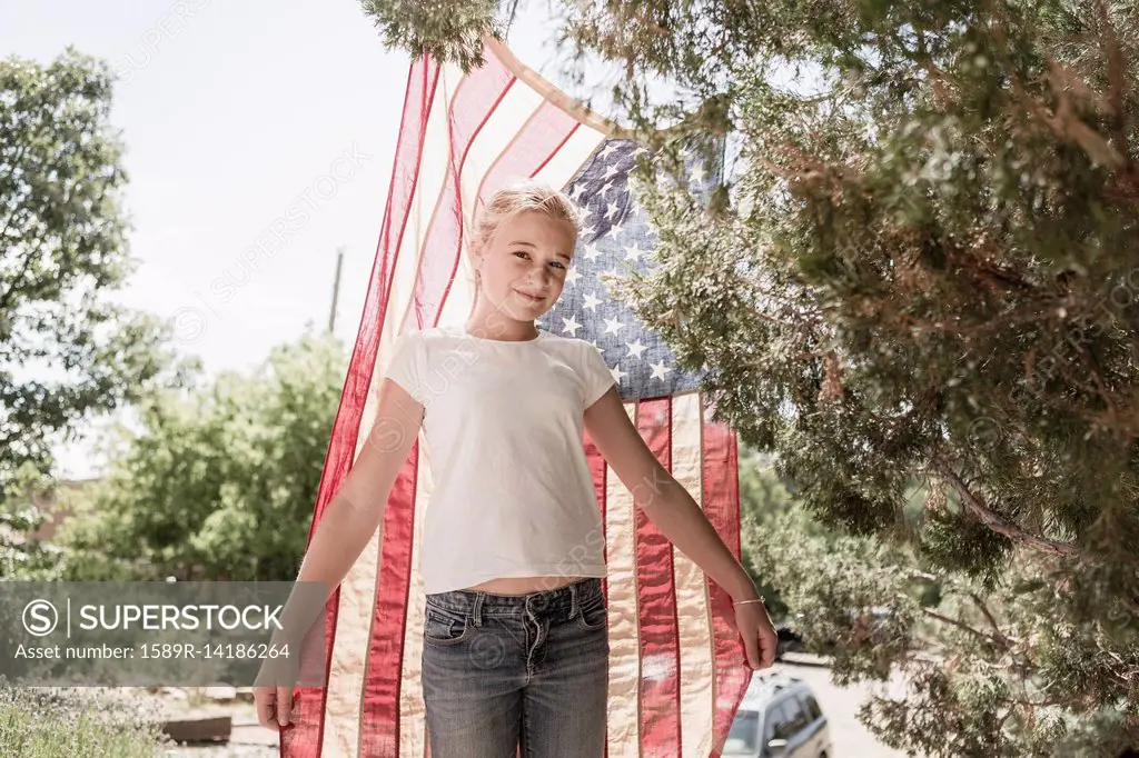 Caucasian girl posing with American flag