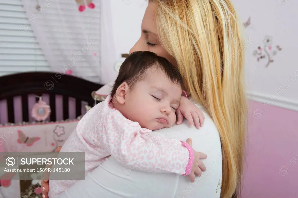 Hispanic mother holding baby daughter