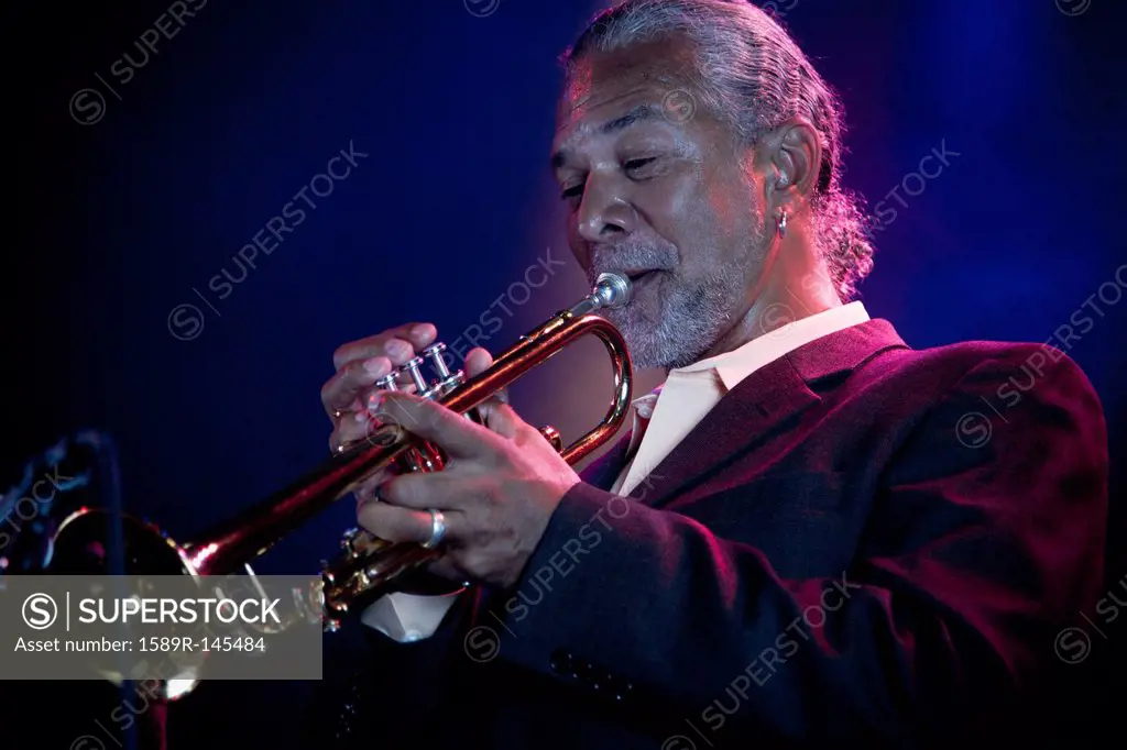 Musician playing trumpet on stage