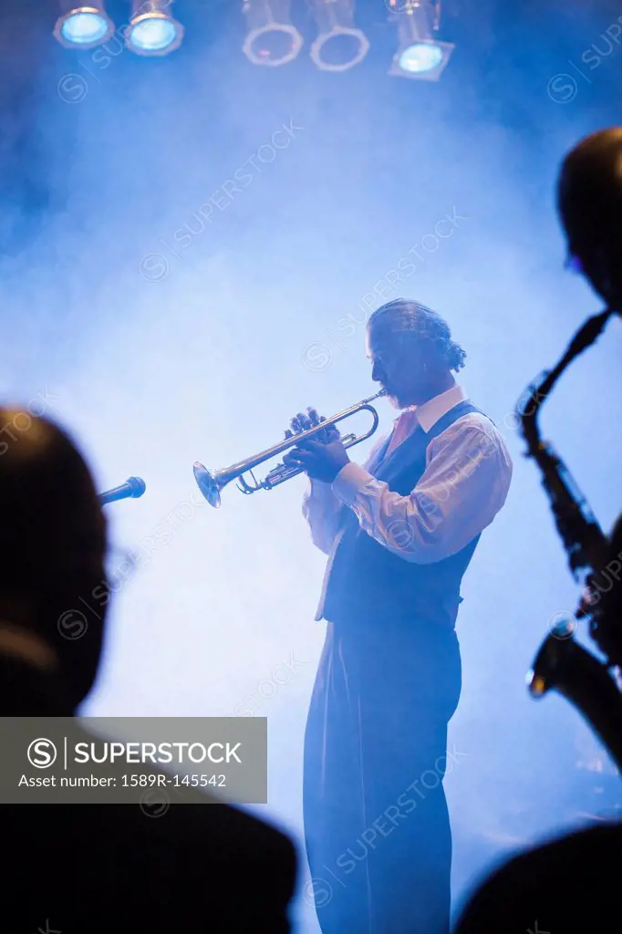 Musician playing trumpet on stage