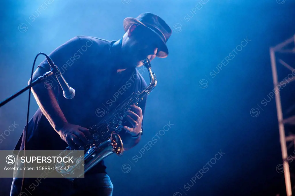 Black musician playing saxophone on stage
