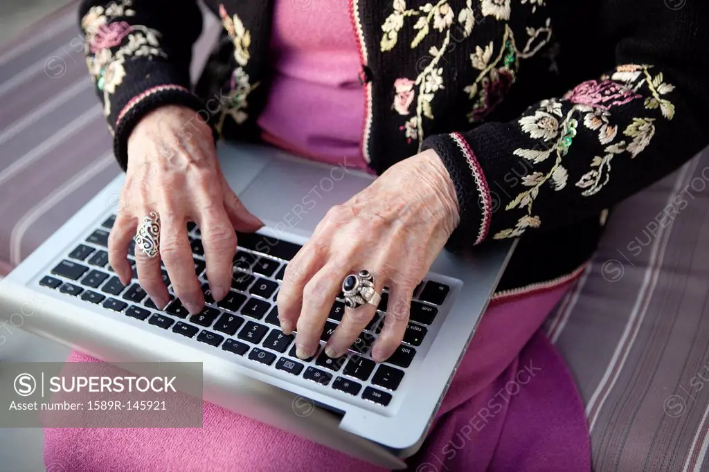 Senior Caucasian woman typing on laptop
