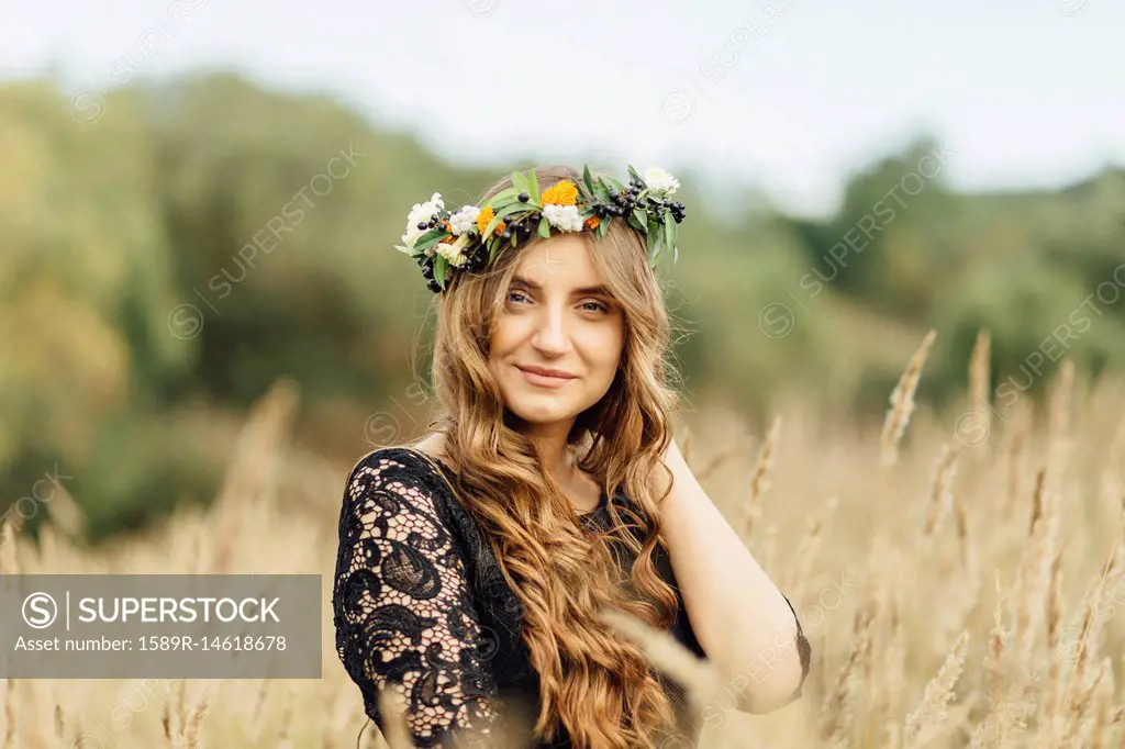 Middle Eastern woman wearing flower crown in field