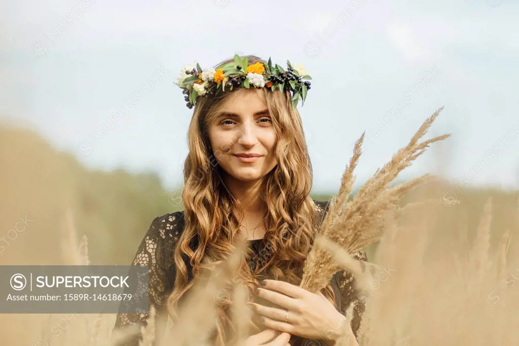 Middle Eastern woman wearing flower crown holding wheat