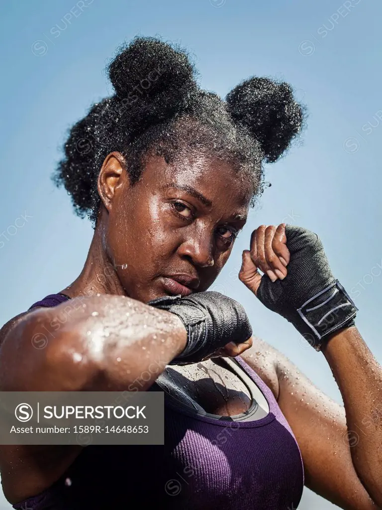Portrait of black woman with hands wrapped for boxing