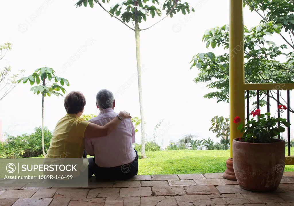 Senior Hispanic couple sitting outdoors together