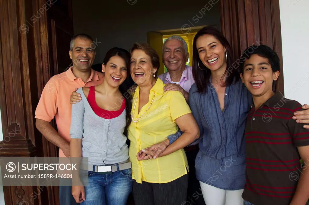 Hispanic family standing in doorway together