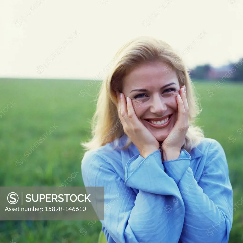 Caucasian woman standing in green field