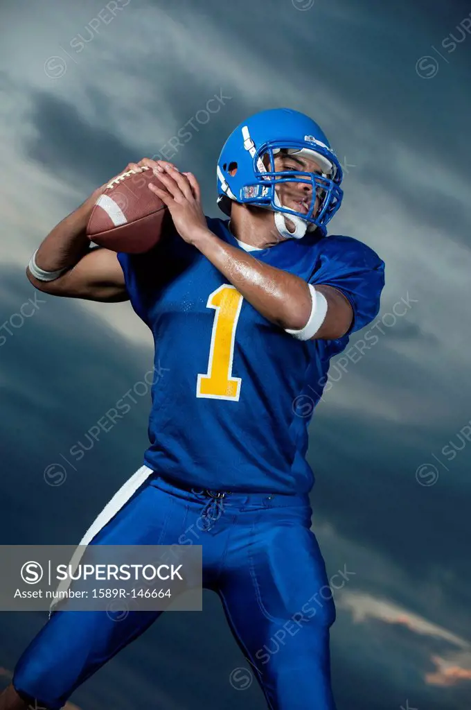 Black football player about to throw football
