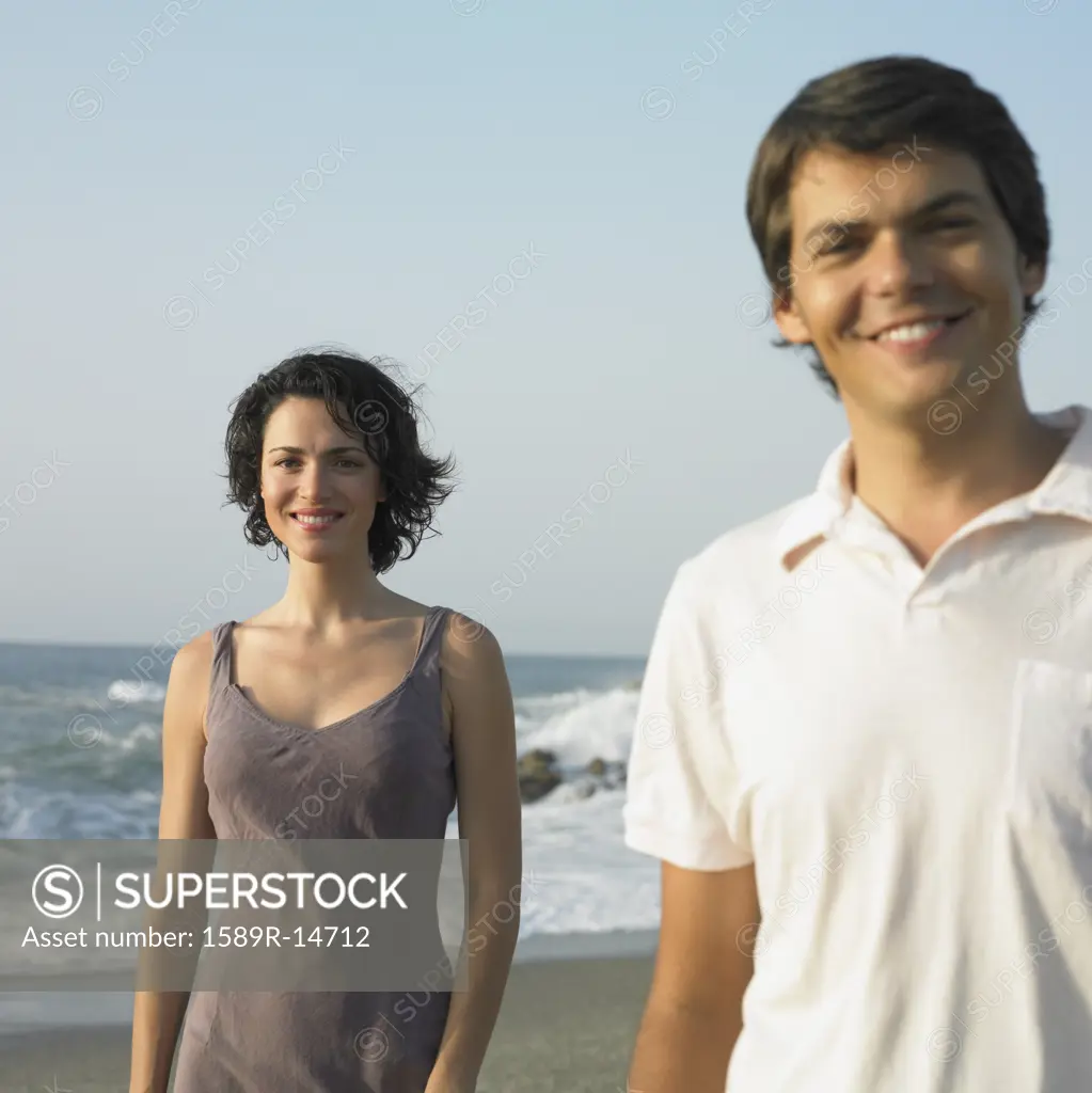 Young couple smiling on beach