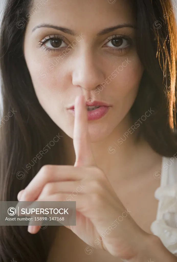 Brazilian woman making shhh gesture