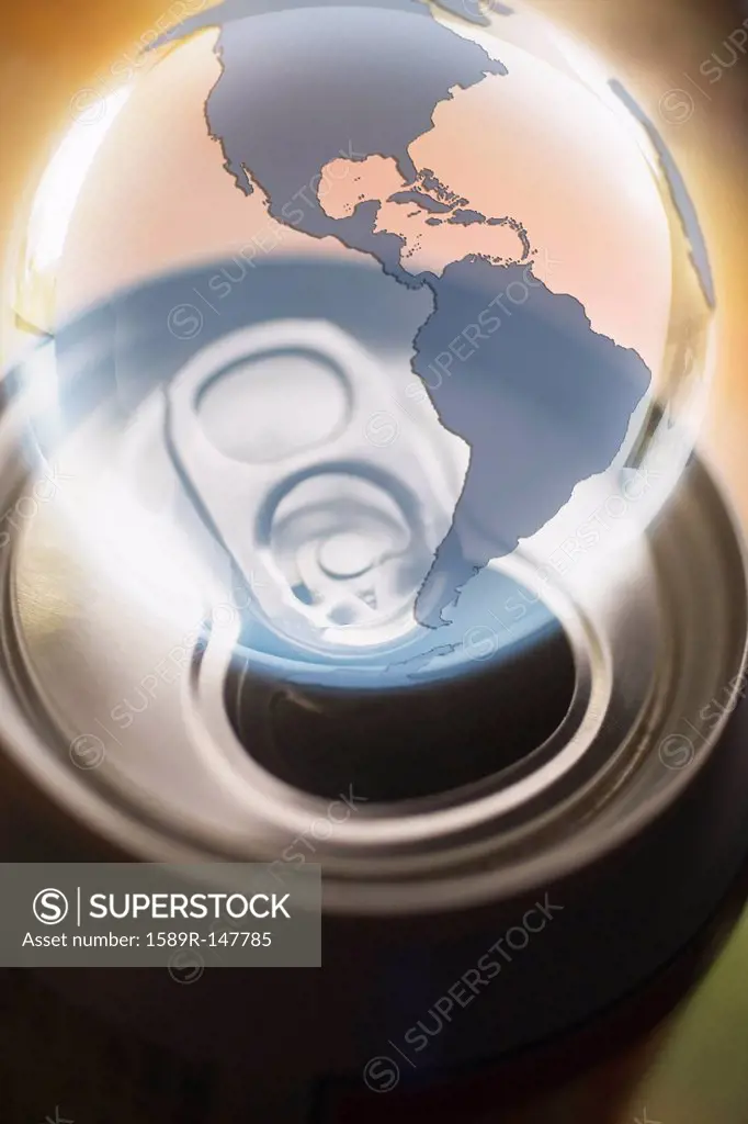 Transparent globe hovering over aluminum can
