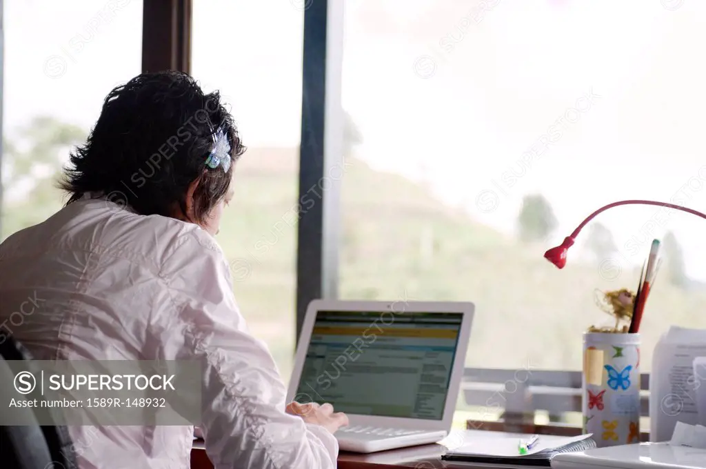 Caucasian woman typing on laptop