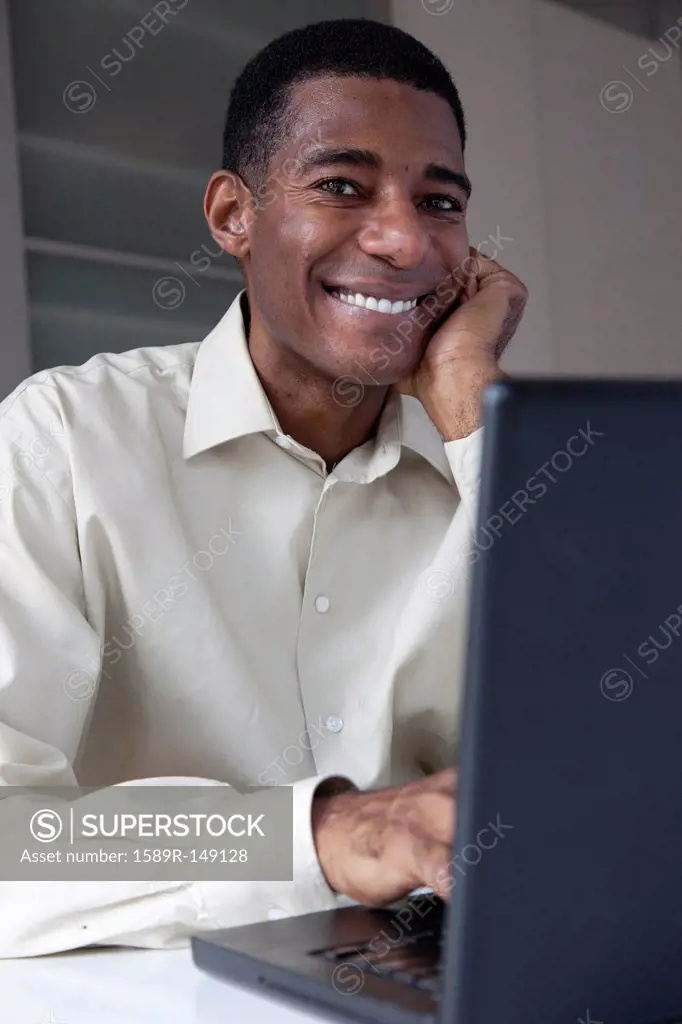 Black businessman typing on laptop