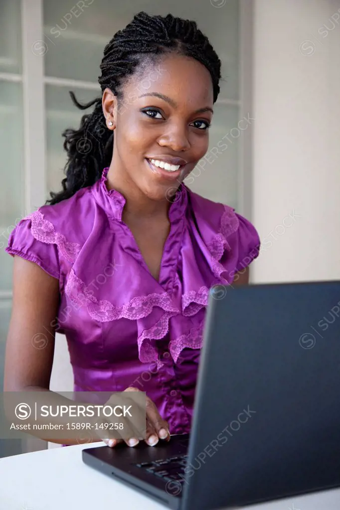Black businesswoman typing on laptop