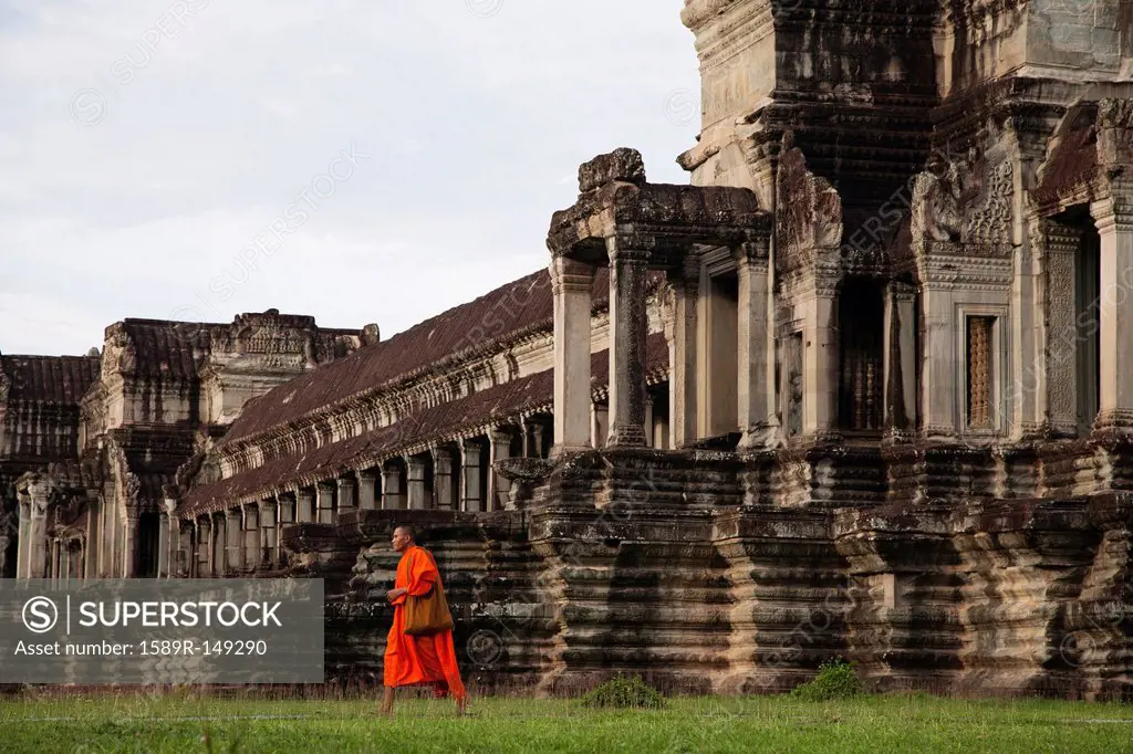 Priest walking near Angkor Wat temple