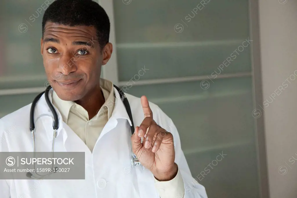 Black doctor in lab coat with hand raised