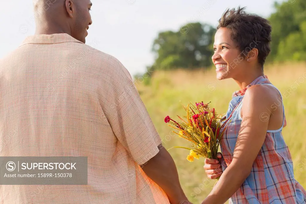 Woman with flowers holding hands with husband