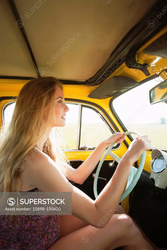 Caucasian woman driving old_fashioned car