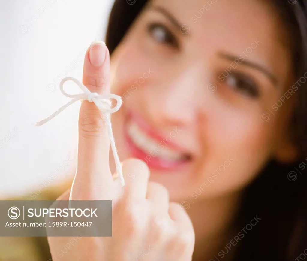 Mixed race woman with bow on her finger