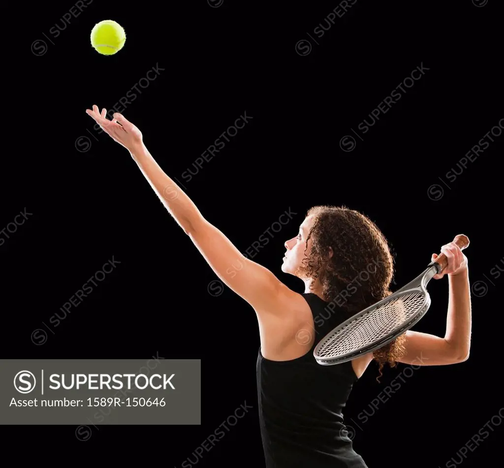 Caucasian tennis player serving the ball