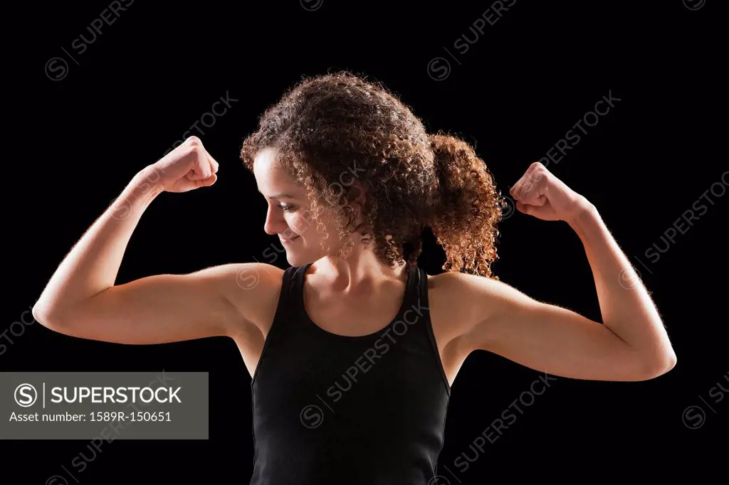 Caucasian woman flexing biceps