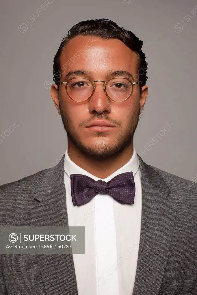 Serious Caucasian man in suit and bow tie