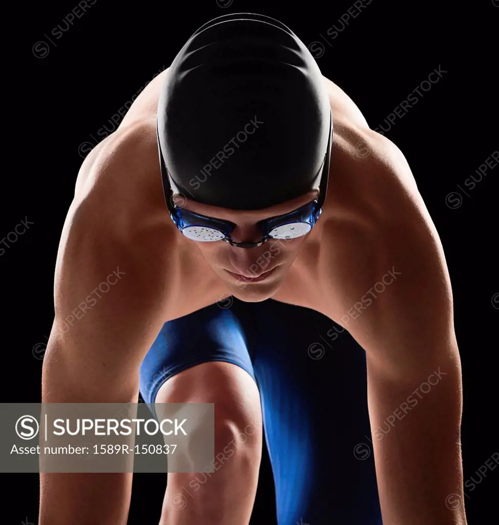 Caucasian teenage boy in swim cap and goggles
