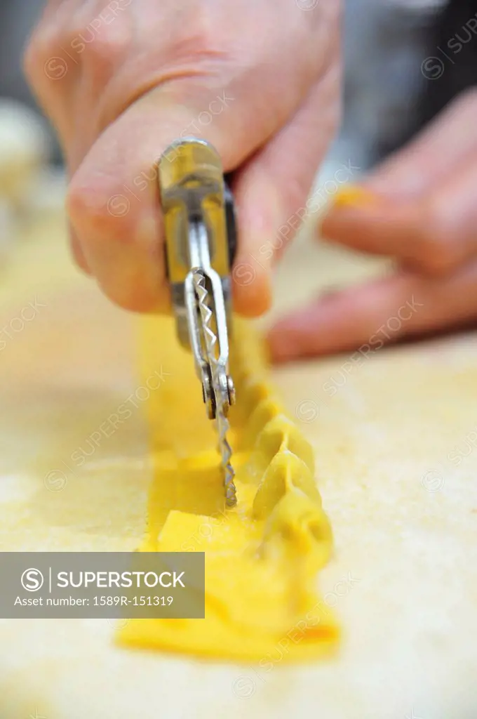 Chef cutting homemade agnolotti pasta