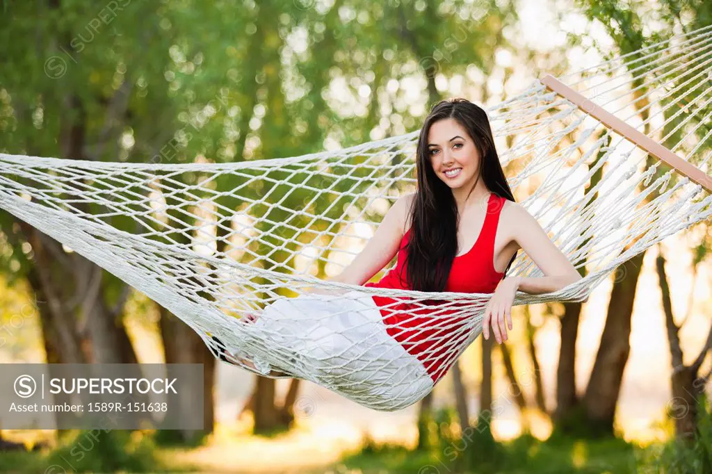 Caucasian woman laying in hammock