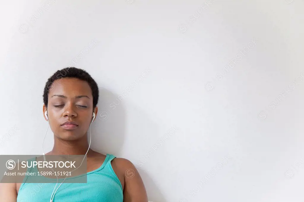 African American woman listening to music on earbuds