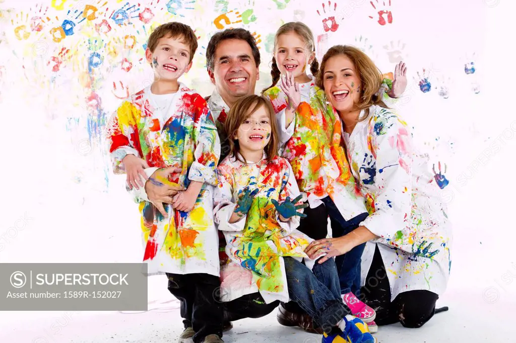Hispanic family covered in paint