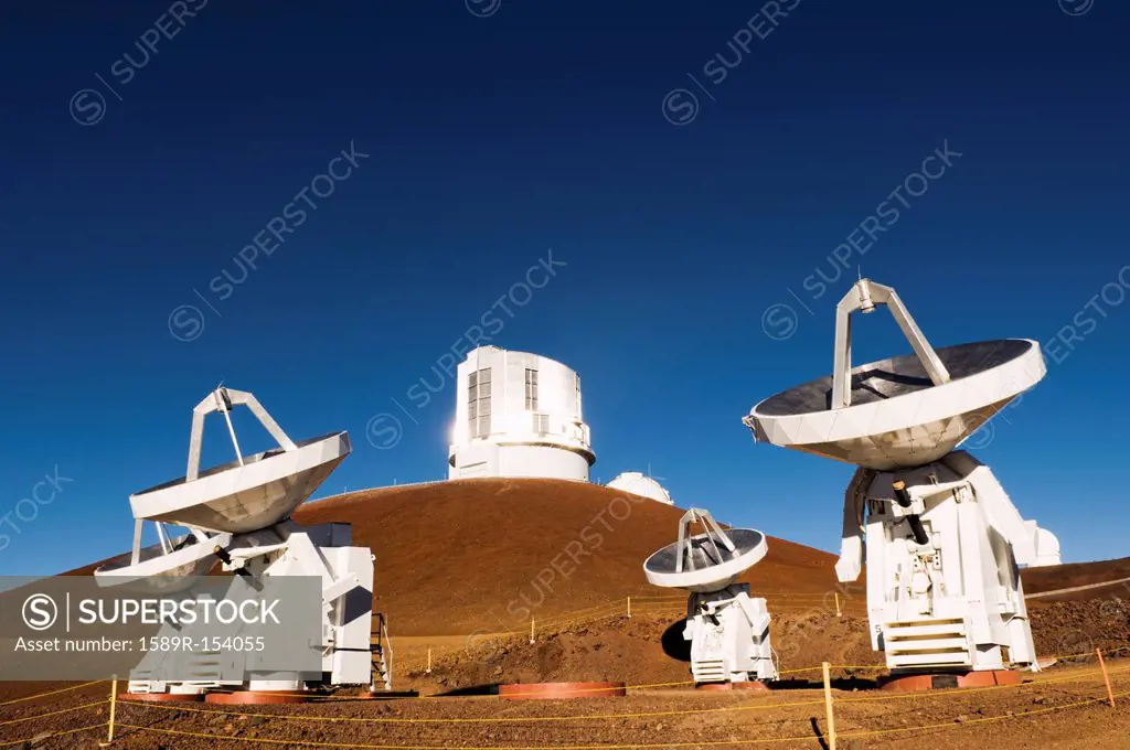 Observatory and satellite dish on hillside